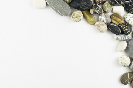 Frame of sea stones on a white background isolationの写真素材