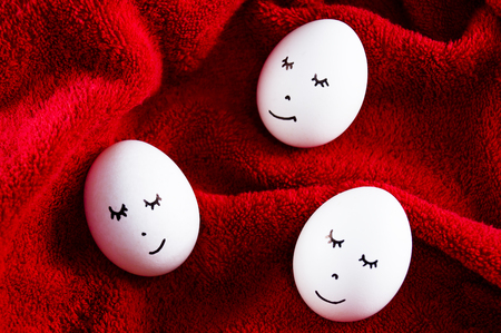 Easter eggs as a symbol of the holiday are sleeping on red backgroundの写真素材