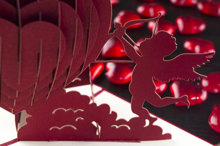 image of the valentine's angels on the table and heart backgroundの写真素材