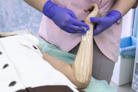 Master sugaring produces hair removal procedure. Natural procedure background.