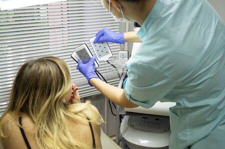 Master beauty center carries out the procedure of losing weight with the help of a special device....