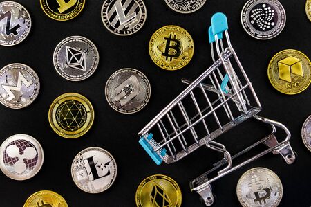 A lot of cryptocurrency coins lie on a dark surface backgroundの写真素材