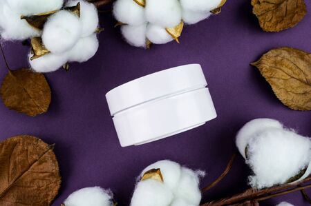Jar of cream on a purple background. Mockup for your label. Natural cosmetics.の写真素材