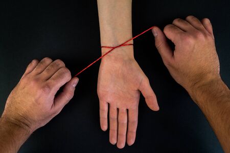 Red thread on a black background in the cartの写真素材