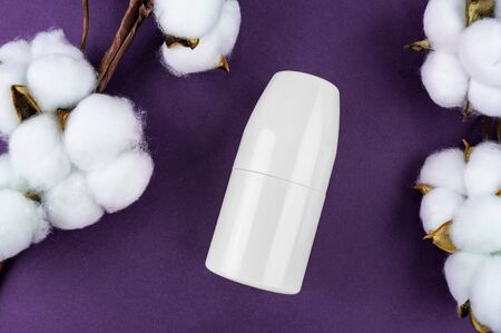 Mockup antiperspirant on a purple background. Cotton and leaves are natural eco cosmeticsの写真素材