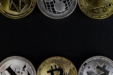 A lot of cryptocurrency coins lie on a dark surface backgroundの写真素材