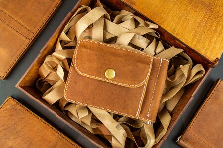 wallet made of genuine leather on the table in the process of packing a giftの写真素材