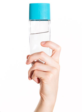 The girl holds perfume in her hand. Image on a white backgroundの写真素材
