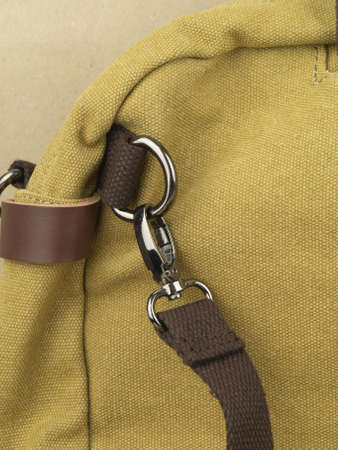Elements on the leather product: belts, fasteners, fasteners, zippers. Close-up image on light...