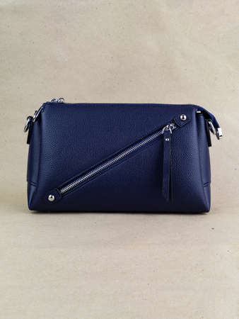 A beautiful women's bag stands on a paper background. small bagの写真素材