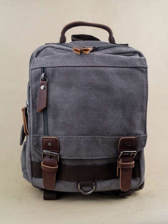 A beautiful hiking backpack is on the table. Photo on a background of craft paperの写真素材