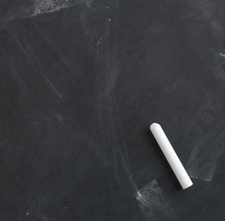 a blank blackboard, chalkboard and chalk straight onの写真素材