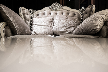 Luxury vintage sofa with reflection on table.の写真素材