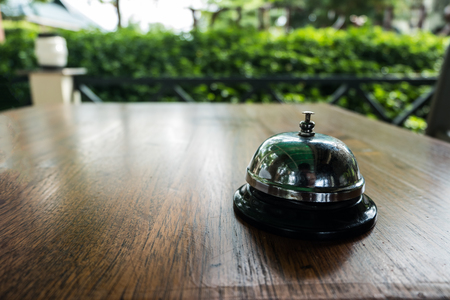 Restaurant bell on table with bokeh for serviceの写真素材