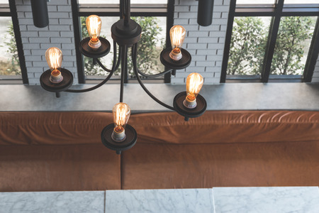 High angle chandelier light interior with table and chair