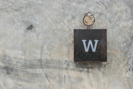 Metal toilet signage on raw concrete textured backgroundの写真素材