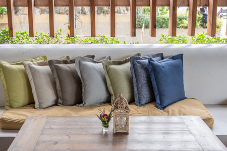 Close up relaxation corner with colorful pillow on sofa and decorated wooden table