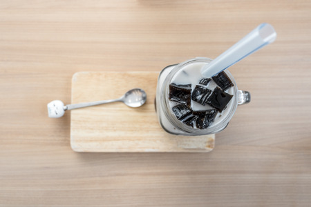 Soy milk with black grass jelly on wooden plateの写真素材