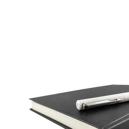 Black notebook and pen over isolated on white background with clipping pathの写真素材