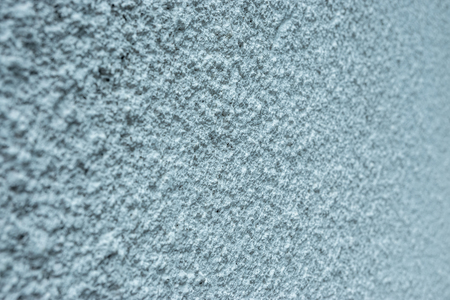 Texture of fine plaster on concrete wall background with shallow depth of fieldの写真素材