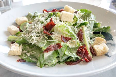 Close up organic caecar salad in white dish with caecar dressing. International food - Imageの写真素材