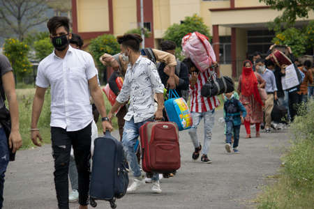 Disaster Pandemic covid -19 corona virus in India . People returning home from different states, countries. Thermal scanning by doctors and administration.のeditorial素材