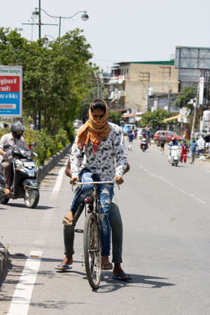 Dehradun, Uttarakhand/India - September 06 2020: Boy riding bicycle covering his face.のeditorial素材