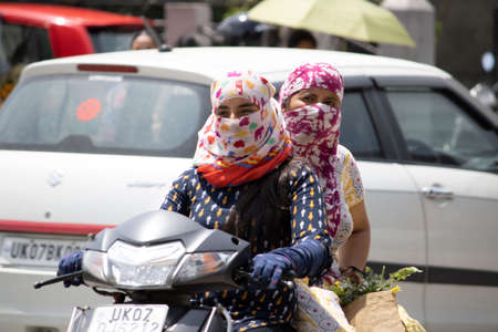 Dehradun, Uttarakhand/India - September 06 2020:Women going on a scooter covering their face.のeditorial素材