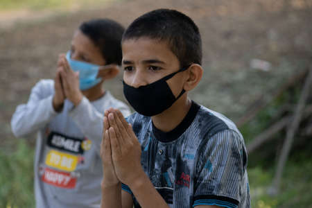 Dehradun, Uttarakhand/India - September 06 2020: Boy does Namaste wearing face mask.