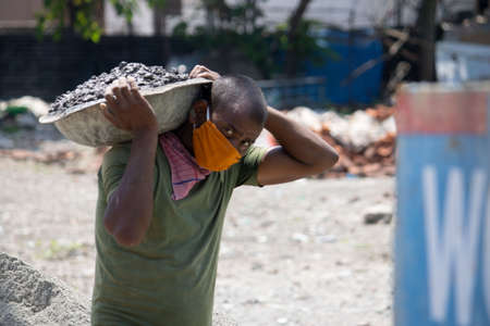 Dehradun, Uttarakhand/India - September 06 2020: men doing labor work wearing face mask.のeditorial素材