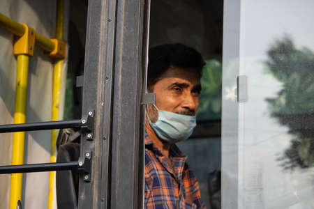 Dehradun, Uttarakhand/India-September 12 2020:A Bus driver wearing face mask in Corona pandemic situation.のeditorial素材