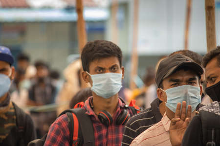 Dehradun, Uttarakhand/India-September 12 2020: Youngsters wearing face mask at railway station, waiting for registration by the official.のeditorial素材