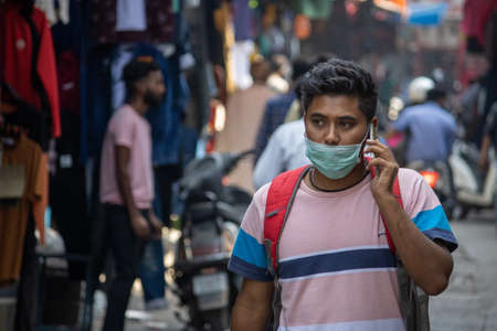 Dehradun, Uttarakhand/India-October 14 2020:A college boy wearing face mask is passing through the market in India, the government in India has made the mask mandatory due to the corona epidemic.のeditorial素材