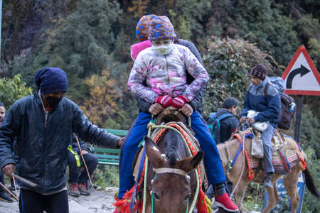Children going kedarnath trek wearing face mask. . High quality photo