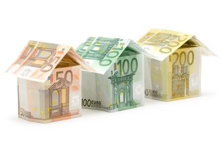 Three colorful houses built of different euro bills. Isolated on a white background. Three colorful houses built of different euro bills. Isolated on a white background.