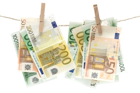 Several different euro banknotes held by a clothesline. Isolated on a white background.