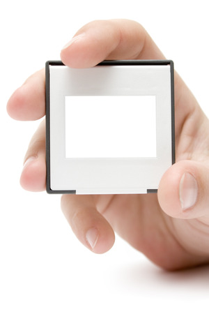 Female hand presenting a picture slide. White background.の写真素材