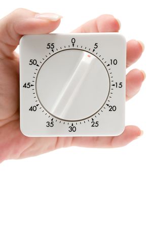 Female hand holding a timer. Isolated on a white background.の写真素材
