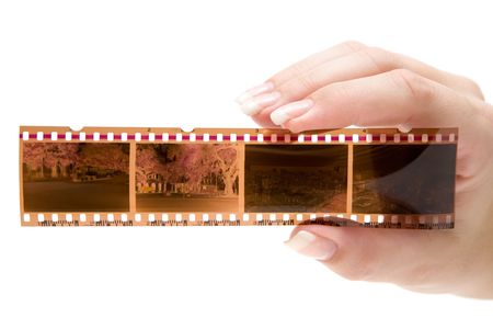 Woman holding a filmstrip. Isolated on a white background.の写真素材