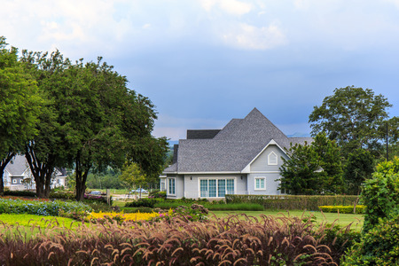 House surrounded by trees and flower.の写真素材