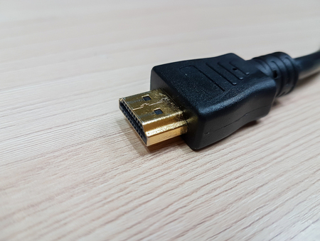 HDMI cable line on wooden background.の写真素材