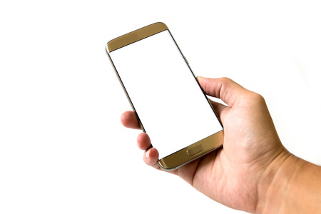 Golden smartphone in right hand isolated on white background.の写真素材
