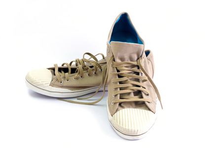 Brown canvas shoes on white background.