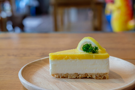 Closeup of a piece of lemon cake in wooden tray on the table.の写真素材