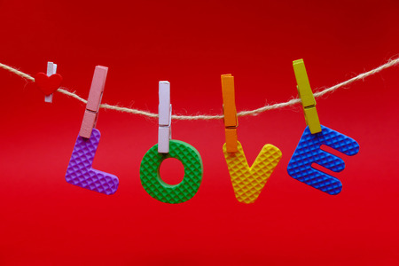 Text of LOVE in valentineÃ¢ï¿½ï¿½s day card on red background.の写真素材