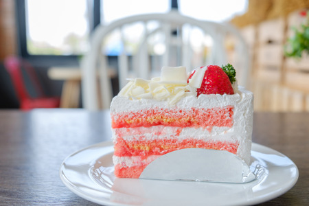 Closeup of a piece of strawberry cake white plate on the table.の写真素材