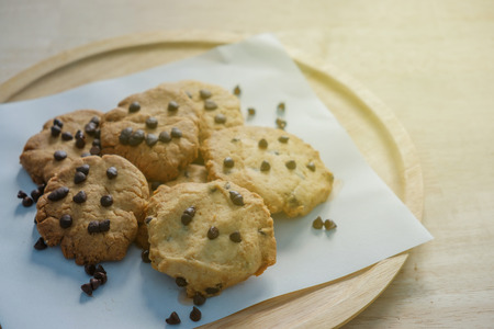 Closeup cookies in wooden tray in warm light.