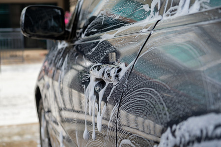 Bubble of car wash around the car.の写真素材