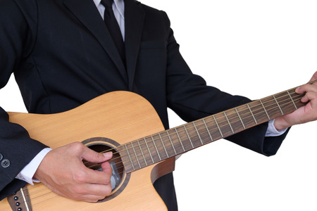 Man in suit playing guitar on white backgroundの写真素材