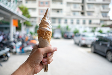 Close up of two tone ice cream in hand.の写真素材